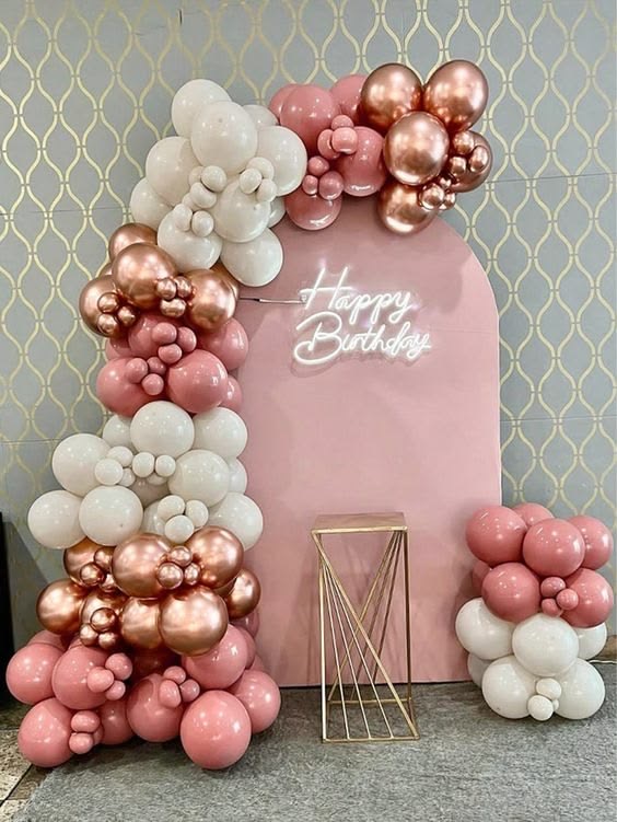 Pink, white and rose-gold balloon arch and backdrop